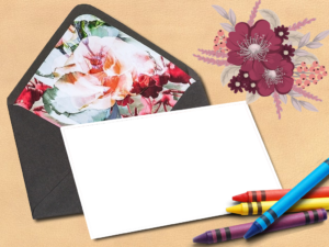 Imikimi flowe with a black envelope with a picture and crayons